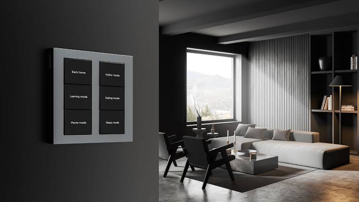 Person installing smart in-wall switch while learning how to automate home lighting system