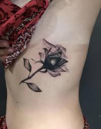 A famous rose design is a rose placed between wings; 29 Most Gorgeous Rose Tattoo Design For Men Women