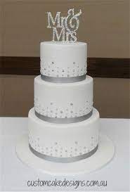 Some may have a small spot of color, as well, and some may be accented in silver or gold. Simple Silver And White Wedding Cake Silver Wedding Cake Wedding Cake Toppers Simple Wedding Cake