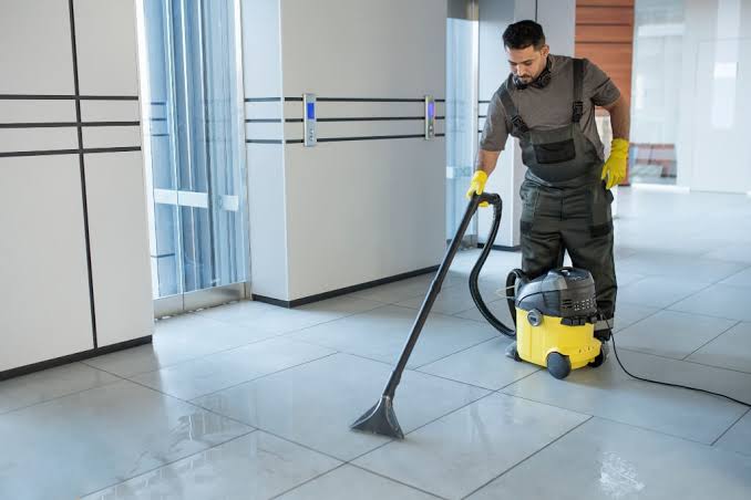 Chislehurst Village Office Cleaners wiping down corporate desk and glass partition