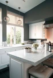 The transitional kitchen's masterpiece is the gorgeous hood with a great island! Lovely Grey Marble Kitchen Kitchen Design Modern White Grey Kitchen Walls Gray And White Kitchen