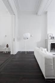 White Minimal Decor Dark Wood Floors White Sofa And Crown Moldings Dark Wood Floors Living Room Brown Living Room Decor Living Room Wood Floor