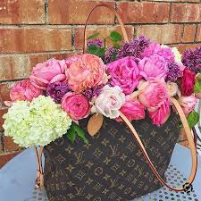 The reade pm features a vernis leather body, flat handles, an open top, and an interior zip pocket. Gorgeous Louis Vuitton Neverfull Mm Handbag Filled With Garden Roses Viburnum And Lilacs For Spring
