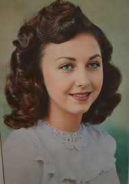 Can someone edit my grandma's photo to have dark brown hair and green eyes?