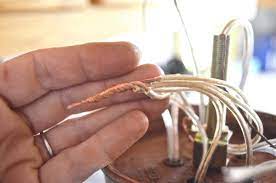 Once you're sure the electricity is off, remove the wire connectors and unwrap any electrical tape to disconnect the fixture's wires from the ceiling. Rewiring A Chandelier At Charlotte S House