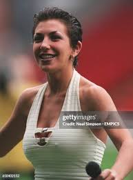 Debbie Currie entertains the crowd before the match News Photo