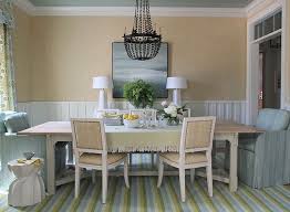 This coastal cottage dining room is decorated in neutrals, punctuated with black & white buffalo check curtains. Blue And Green Cottage Dining Room Cottage Dining Room Andrew Howard Interior Design