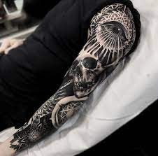 A flawless black and grey sleeve tattoo design that features a skill. Dark Sleeve Skull Sleeve Tattoos Tattoos Sleeve Tattoos