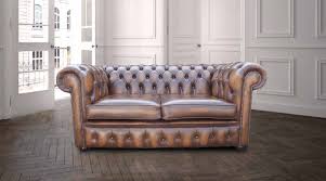 A classic high back chair. Chesterfield Handmade 2 Seater Antique Tan Real Leather Sofa Designer Sofas4u