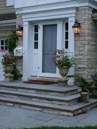 Paver walkway, natural stone steps and flanking pillars create a dramatic entrance. Bluestone Front Entry Stoop Front Porch Steps Front Door Steps Concrete Front Porch
