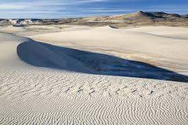 The killpecker sand dunes stretch 55 miles (89 km) east from the green river basin across the continental divide into the great divide basin and encompass approximately 109,000 acres (440 km 2 ). Killpecker Sand Dunes
