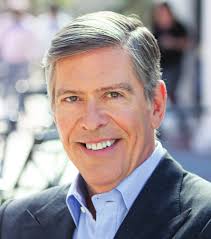 What do top executives make compared to median workers?