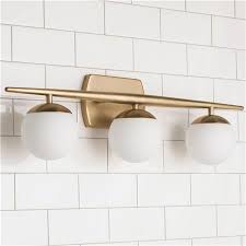 Crafted from sturdy steel, this fixture will stay strong when hung over your vanity mirror or in your bathroom. Linear Globe Bath Light 3 Light Modern Bathroom Lighting Bathroom Light Fixtures Mid Century Modern Bathroom