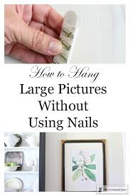 How To Hang Large Pictures Without Using Nails The Crowned Goat Hanging Pictures Hanging Pictures Without Nails Hanging Pictures On The Wall