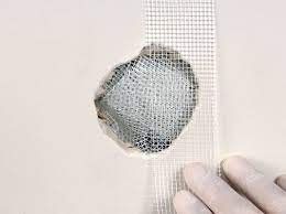 You'll need someone to hold the ladder for maximum safety. Diy Home Repair How To Fix Drywall Holes Yourself For Cheap Better Housekeeper