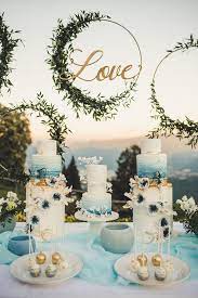 Round Hanging Metal Love Sign Cakes On Cake Stands Small Bites In Plates Wedding Table Decorations Wedding Cake Table Sweet Table Wedding Wedding Cakes Blue