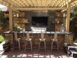 It may be outdoors, but it's still a part of your home—as such, it should feel connected to the rest of your space, so make sure to give it some love. Tv Wall And Outdoor Kitchen Outdoor Bbq Kitchen Backyard Kitchen Outdoor Kitchen Patio