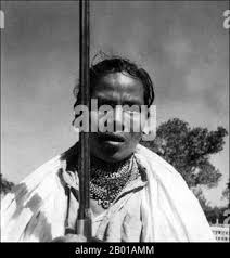 Black and white image of family of five enjoying time together in a park,  parents lifting the oldest child holding his hands Stock Photo