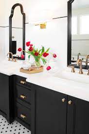 Great island and hood and the cabinets are black and white color patterns are simple yet elegant, whereas usage of colors like yellow and turquoise. Bright Bath With Dark Wood And White Counters Black Cabinets Bathroom White Bathroom Tiles Classic Bathroom