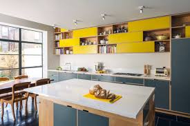 This kitchen offers yellow and glass front cabinets along with a small island that's topped with a wooden counter. Yellow Kitchen Cabinets Houzz