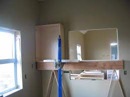 If you're installing both upper and lower kitchen cabinets in the same spot, make sure there's plenty of space between them for appliances and countertops (about 17 should be enough for most appliances). Installing Cabinets Uppers Or Lowers First