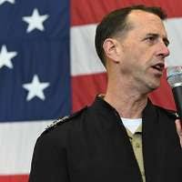 Air Force Lt. Gen. Ken Wilsbach, left, smiles after