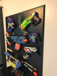 Space out 2 pegs at approximately the same length as the nerf gun and hang the gun over the pegs. Ryan Homes Venice Customization Nerf Gun Wall