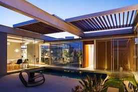 A patio pergola attached to the house is the perfect way to define an outdoor space. Beautiful Pergola Designs That Perfectly Frame These Modern Houses
