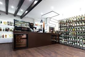 These Holes Are Perfectly Lit By Led Lights Highlighting The Greenish Dark Red Tones Of Wine Bottles Making The Be Wine Store Design Store Design Wine Store