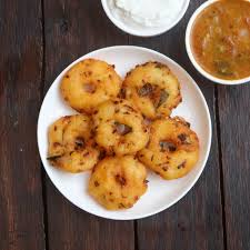 Crispy medu vada coated with spicy podi (gunpowder) served with sambar and chutney