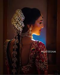 For brides, twisted vintage buns or high buns accessorized with flowers or embellished pins are great ideas. Beautiful South Indian Bridal Hairstyle For A Gorgeous Bridal Look
