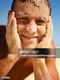 Man At The Beach With Sand On His Face High-Res Stock Photo