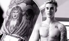 One of the justin bieber tattoos shown is a picture of an angel. Justin Bieber Wants To Erase Tattoo Of Ex Girlfriend Selena Gomez Daily Mail Online