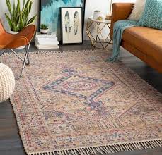 A living space featuring a brown leather couch set on the red rug in front of the artistic wall decor. 15 Beautiful Rugs That Go With Brown Couches Some Of These Might Surprise You Decor Aid