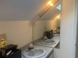 / the room has a very strong exhaust fan at floor level venting out of the house (not the unfinished attic space.). Sloped Bathroom Ceiling