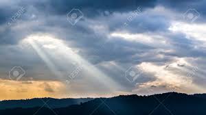 Gorgeous an promising scene of dark mountain range and foggy valley in the first rays of the sun beaming through clouds in the summe. Sunset Over Beautiful Blue Sky With Sun Shining Through Clouds Stock Photo Picture And Royalty Free Image Image 72165689