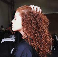 Model With Bold Red Hair And Tight Spiral Curls Curly Hair Styles Haircuts For Curly Hair Balayage Hair Dark