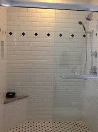 White Subway Tile Shower With Black Accents Black White Mosaics In The Shower Niche And Floor And A White Subway Tile Shower Shower Tile White Tile Shower