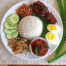 A plate of nasi lemak can be rather plain or with fried anchovies, fried peanuts, boiled eggs, cucumbers. Something By Tauhhid Makan The Wonderful Nasi Lemak