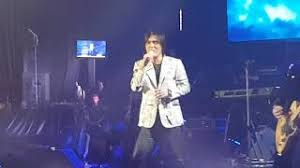 Woman in white spaghetti strap dress standing on green grass field under white clouds during daytime. Lagu Malaysia Sayap Sayap Patah Mp3 Video Mp4 3gp M Lagu123 Fun