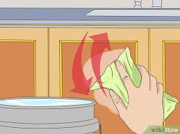Apply baking soda again on the same cloth, and rub gently the stubborn stains, especially the stained ones. 3 Ways To Clean Greasy Kitchen Cabinets Wikihow