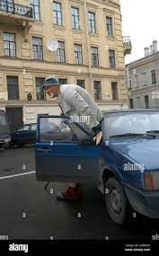 The highest basketball player in the history of basketball needs help.  September 27,2004. St.Petersburg,Russia. Pictured: Alexander Sizonenko and  his Lada car. Alexander Sizonenko is suffering Osteoporosis (Osteoporosis  is a condition characterized by