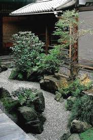 A traditional japanese water basin overlooks the scene below. Japanese Indoor Garden Design Japanese Garden Japanese Landscape Zen Garden Design