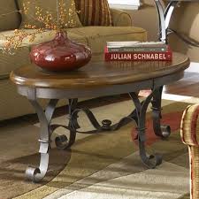 The riverside furniture nadene drum coffee table brings simple styling and quality craftsmanship to your home by featuring a durable hardwood frame wrapped in textured metal. Riverside Stone Forge Oval Coffee Table With Iron Base 31002 Riverside Furniture