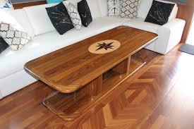 A teak and walnut boat table with maple pinstripes. Interior Tables Blue Water Chairs