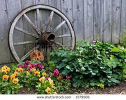 An Old Wagon Wheel Makes A Great Prop In The Garden By Scott T Slattery Via Shutterstock Wagon Wheel Decor Decorative Wagon Wagon Wheel
