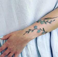 Shared By Sofia Find Images And Videos About Blue Flowers And Tattoo On We Heart It Simple Wrist Tattoos Meaningful Wrist Tattoos Wrap Around Wrist Tattoos