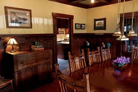 This central living room and dining room are typically only separated by an arch, and the craftsman and the craftsman mission style lighting is generally more humble than showy. Marathon Road Lambakis Interior Design