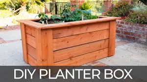 To build a wooden planter box, start by cutting some wooden planks so you have 2 that are 2 feet long and 2 that are 4 feet long. Diy Raised Planter Box W Hidden Wheels Free Plans How To Build Youtube