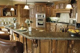 Black vertical sidings for walls, vintage lamps and sisal rope cabinet handles. The Interior Of A Rustic Country Kitchen Featuring An Elegant Stove With Built In Wooden Cabinetry And Marble Countertops Stock Photo Picture And Royalty Free Image Image 2551286
